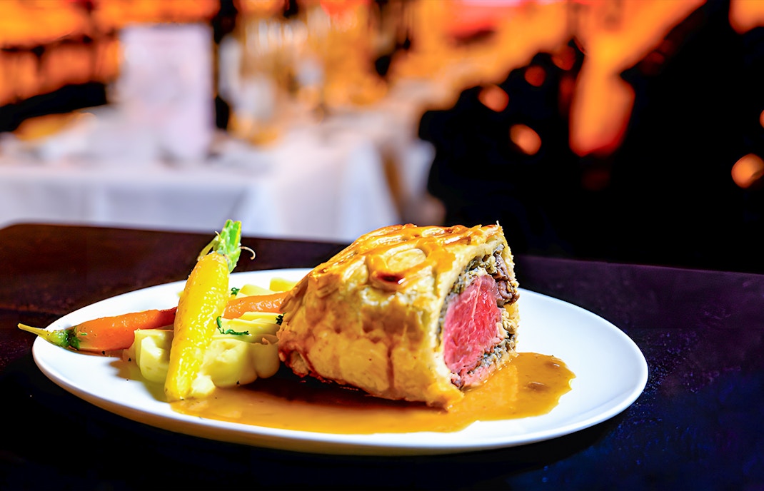 Paradis Latin cabaret show with festive Christmas Eve dinner setup in Paris.