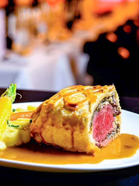 Beef Wellington served with vegetables at Paradis Latin.