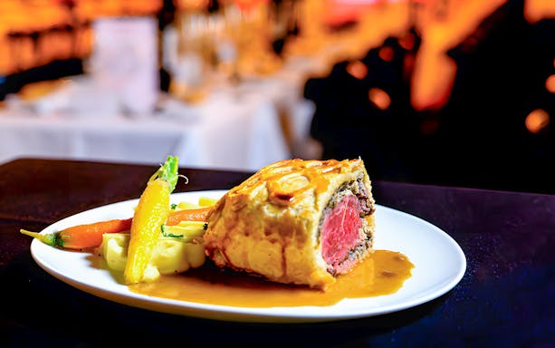 Beef Wellington served with vegetables at Paradis Latin.