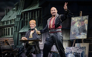 Stage scene from Moulin Rouge! The Musical West End with actors in period costumes.