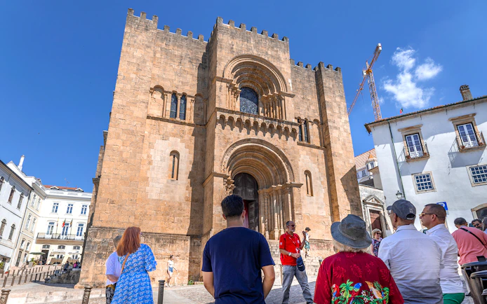 Tour group at the Old Cathedral of Coimbra during Fátima & Coimbra full-day tour from Porto.
