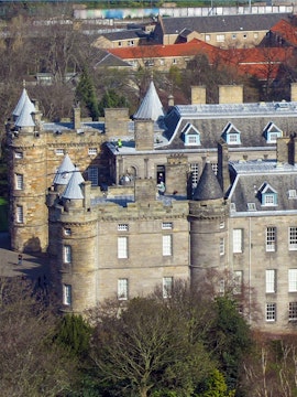 Palace of Holyroodhouse with turrets and stone facade in Edinburgh, Scotland.