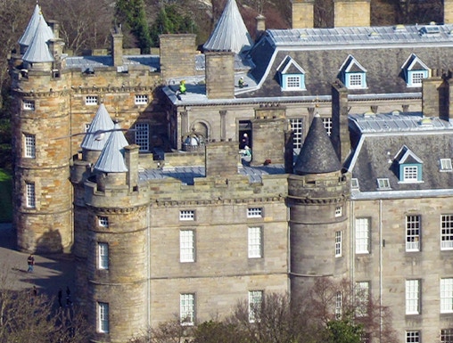Palace of Holyroodhouse with turrets and stone facade in Edinburgh, Scotland.
