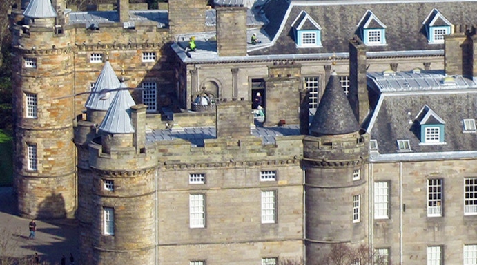 Palace of Holyroodhouse with turrets and stone facade in Edinburgh, Scotland.