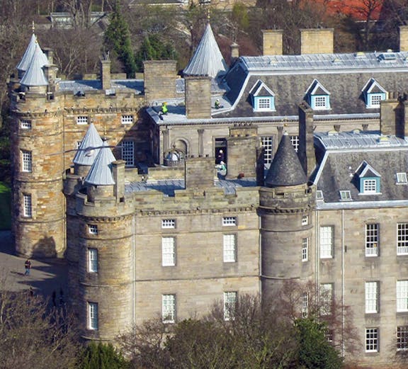 Palace of Holyroodhouse with turrets and stone facade in Edinburgh, Scotland.
