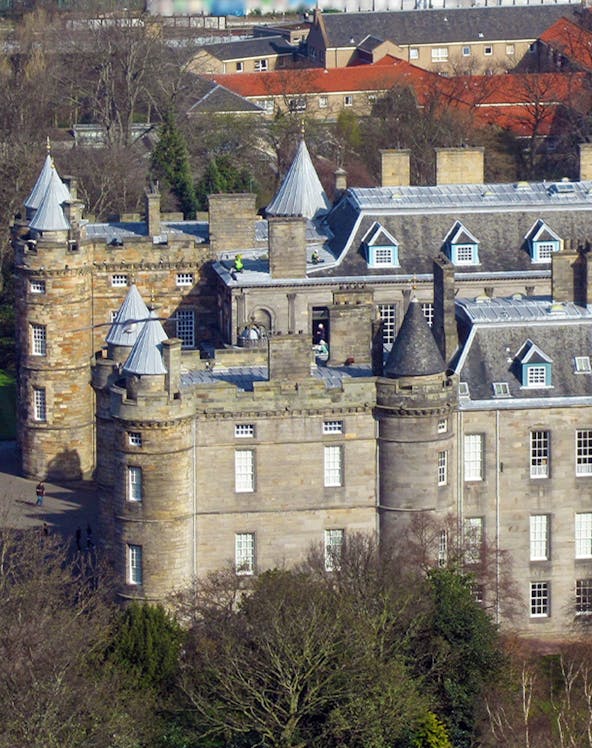 Palace of Holyroodhouse with turrets and stone facade in Edinburgh, Scotland.