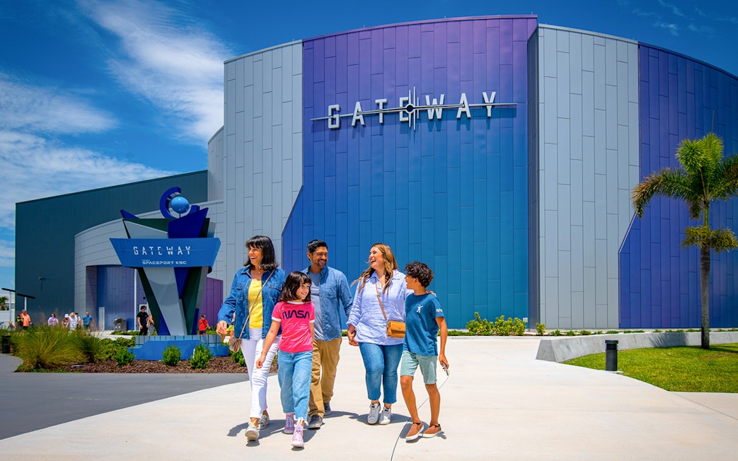 Visitors walking outside the Gateway building at Kennedy Space Center.