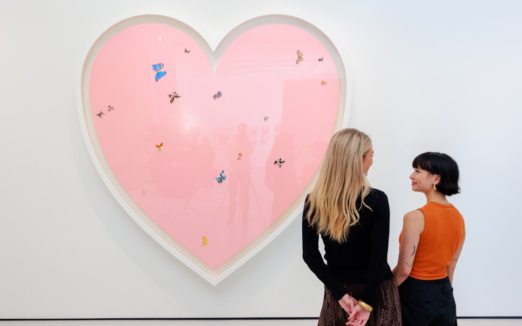 Guests viewing heart-shaped art with butterflies at Moco Museum London.