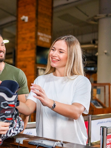 Couple receiving ski equipment at Ski Dubai.