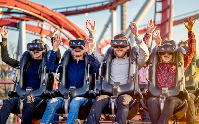 Visitors enjoying a VR roller coaster at Tivoli Gardens, Copenhagen.