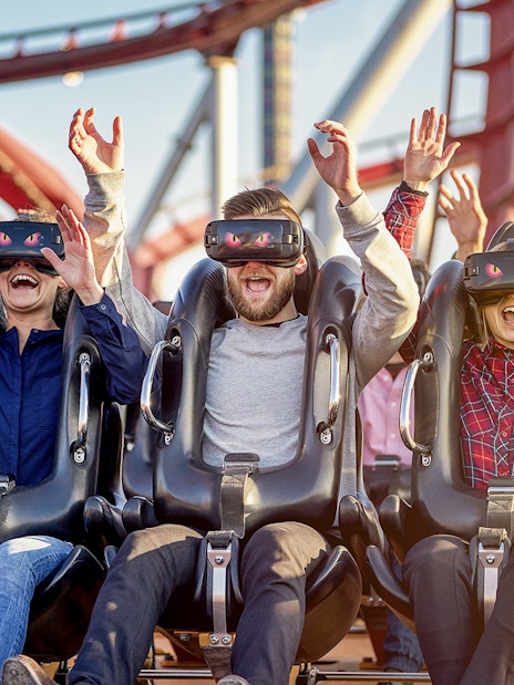 Visitors enjoying a VR roller coaster at Tivoli Gardens, Copenhagen.