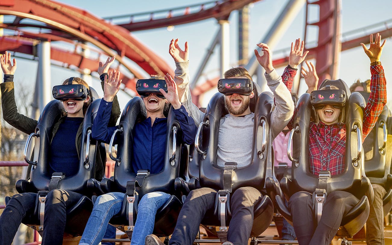 Visitors enjoying a VR roller coaster at Tivoli Gardens, Copenhagen.