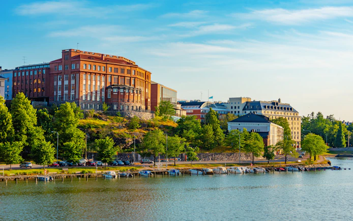 Marina view in Kruununhaka district, Helsinki, Finland with boats and historic buildings.
