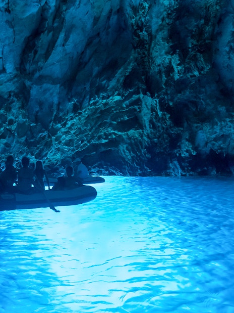 Boat tour inside a glowing blue cave on Dubrovnik Island-Hopping Cruise in the Elaphites.