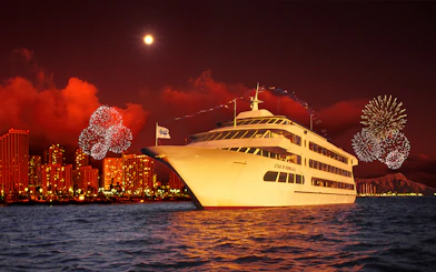 Cruise ship near Honolulu skyline with fireworks in Hawaii.