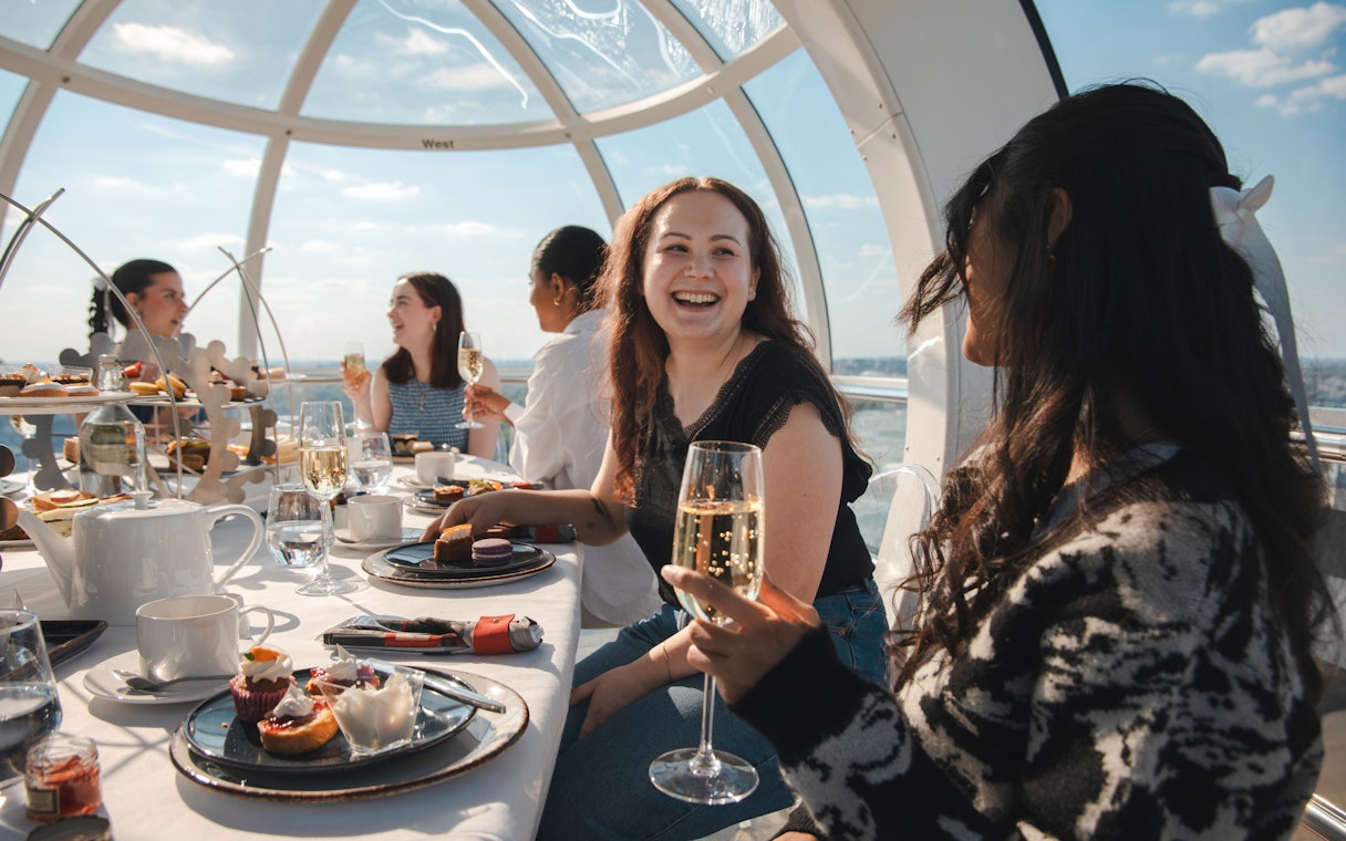 Guests enjoying afternoon tea inside a London Eye capsule.