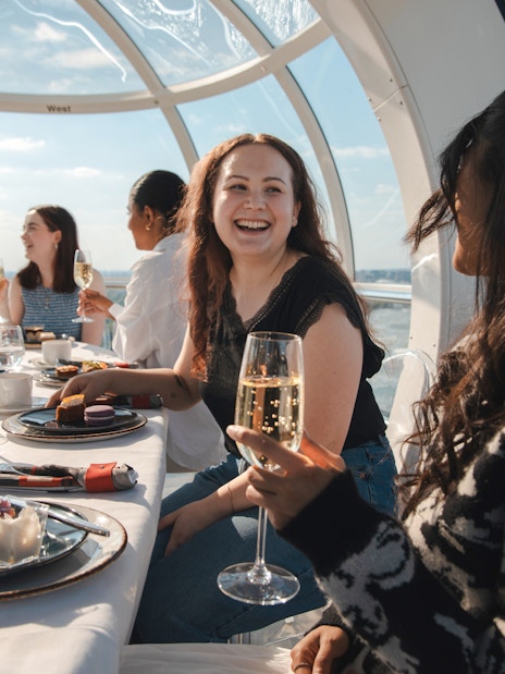 Guests enjoying afternoon tea inside a London Eye capsule.