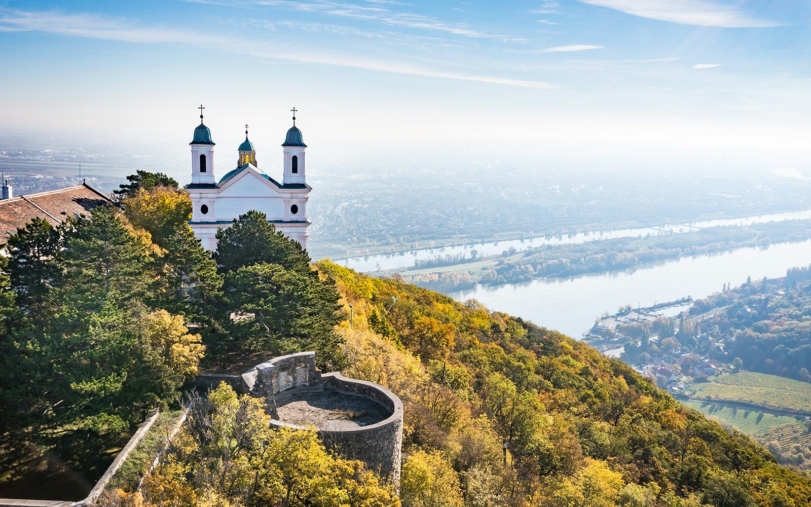 Leopoldsberg hilltop view overlooking Vienna cityscape and Danube River.
