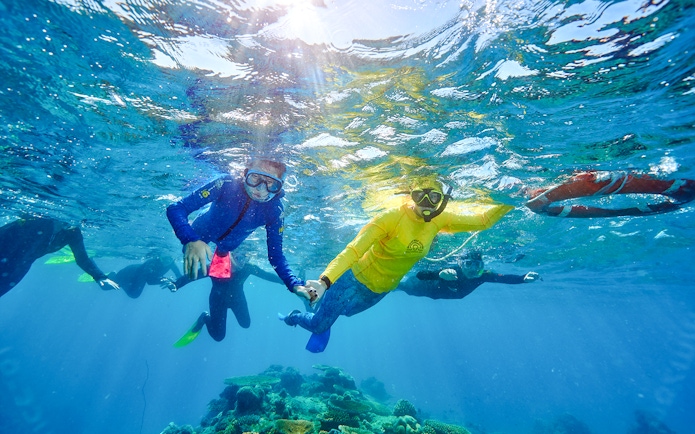 Snorkelers exploring coral reefs near Fitzroy and Green Islands.