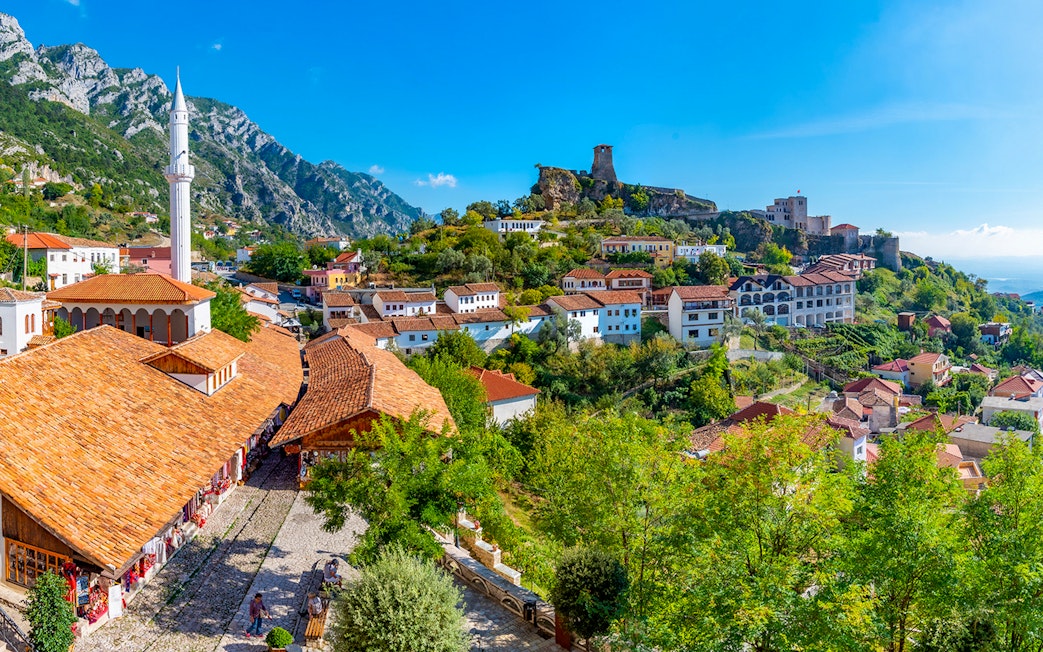 Aerial view of Kruja Castle and bazaar with surrounding village and mountains in Albania.