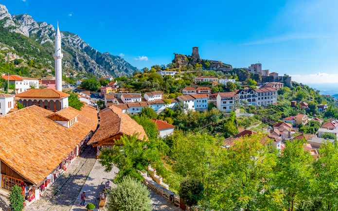 Aerial view of Kruja Castle and bazaar with surrounding village and mountains in Albania.