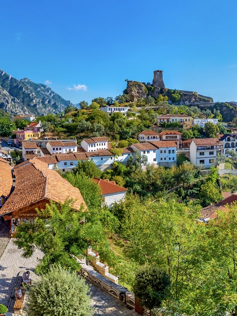 Aerial view of Kruja Castle and bazaar with surrounding village and mountains in Albania.