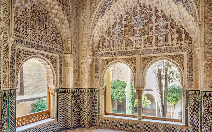 Intricate Moorish architecture inside Alhambra's Nasrid Palaces, Granada, Spain.