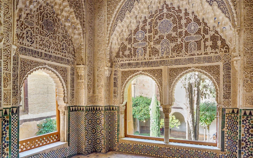 Intricate Moorish architecture inside Alhambra's Nasrid Palaces, Granada, Spain.