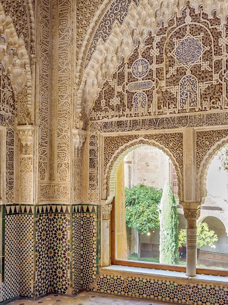 Intricate Moorish architecture inside Alhambra's Nasrid Palaces, Granada, Spain.