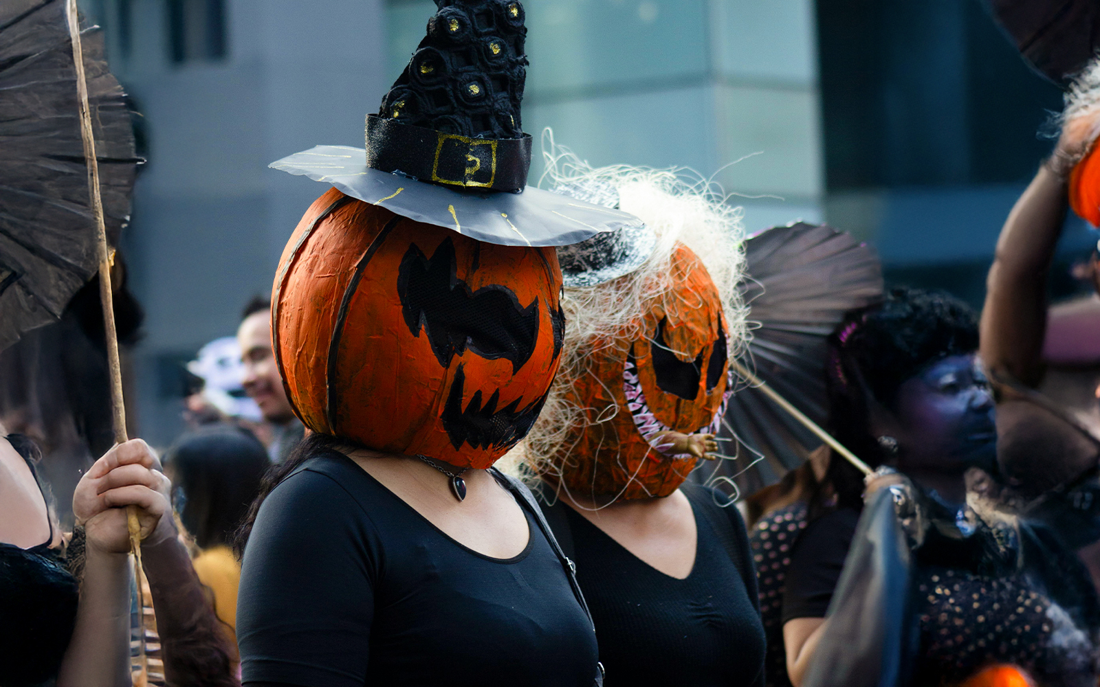Participants in pumpkin head costumes at Halloween parade, New Orleans.