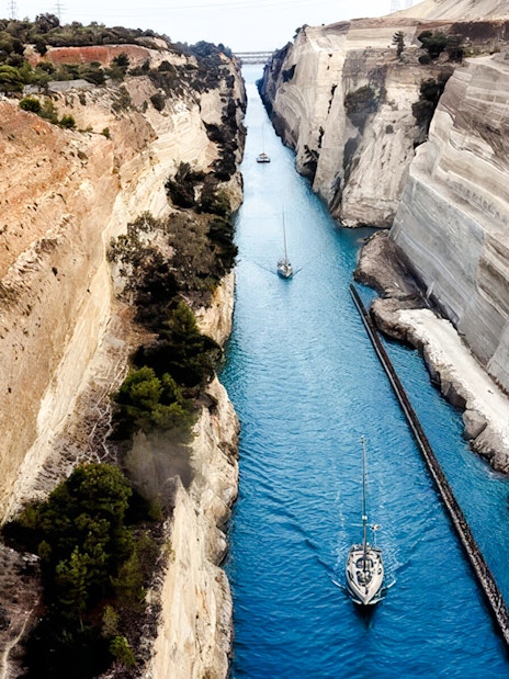 Sailboats navigating the narrow Corinth Canal in Greece.