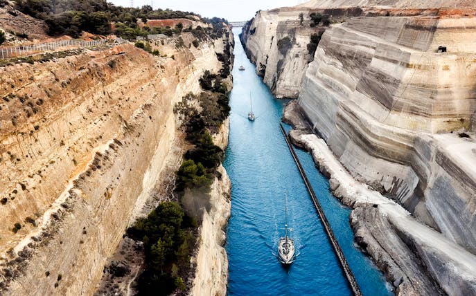 Sailboats navigating the narrow Corinth Canal in Greece.