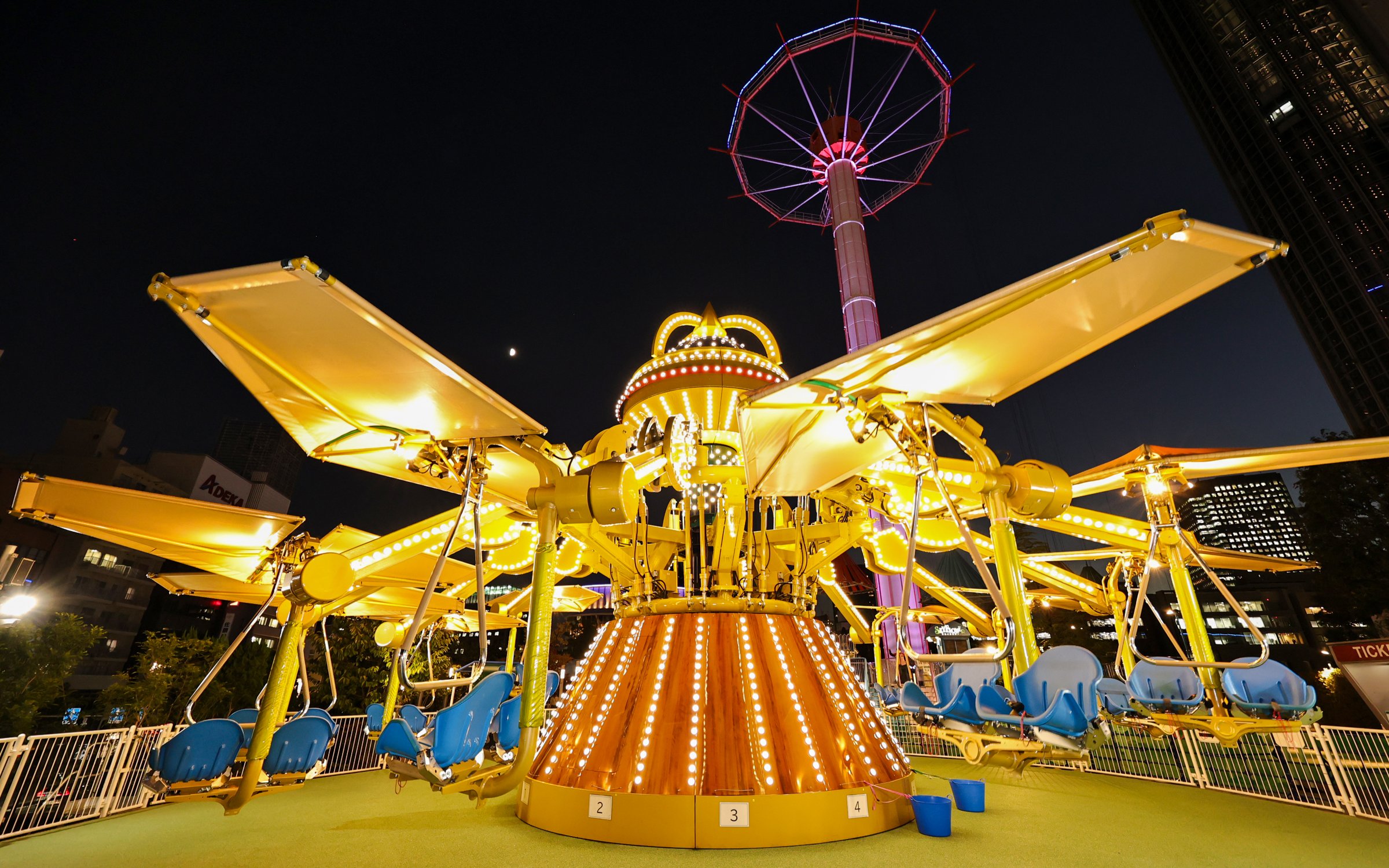 Carousel ride illuminated at night at Tokyo Dome.