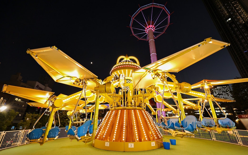 Carousel ride illuminated at night at Tokyo Dome.