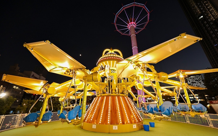 Carousel ride illuminated at night at Tokyo Dome.