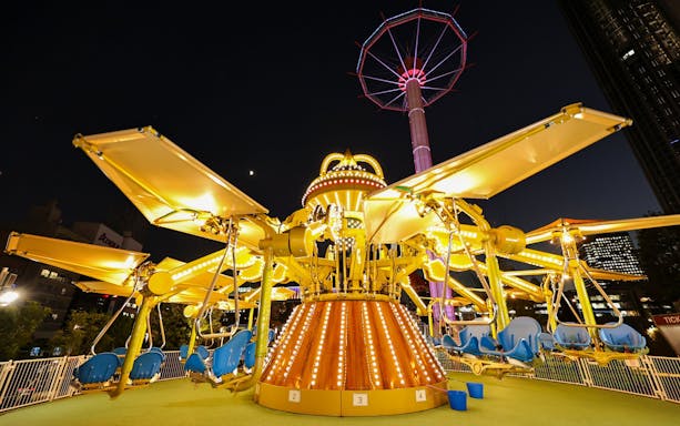 Carousel ride illuminated at night at Tokyo Dome.