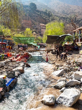 Colourful waterside restaurants along a stream in the Ourika Valley, Morocco.