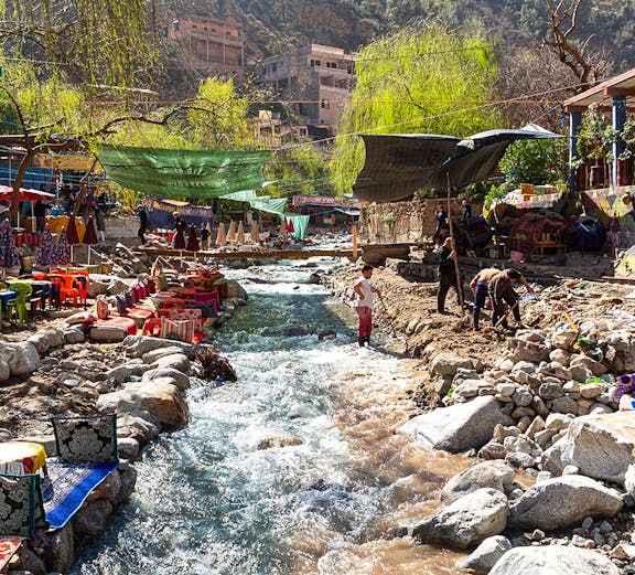 Colourful waterside restaurants along a stream in the Ourika Valley, Morocco.