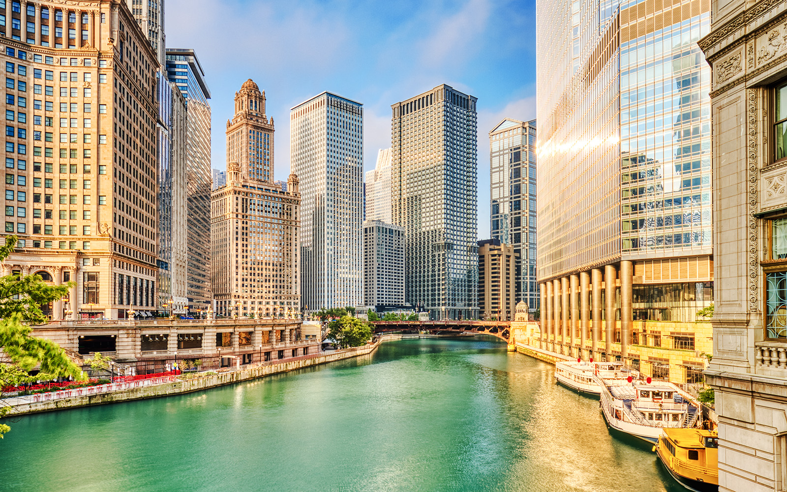 Chicago River with skyscrapers at sunrise in downtown Chicago.