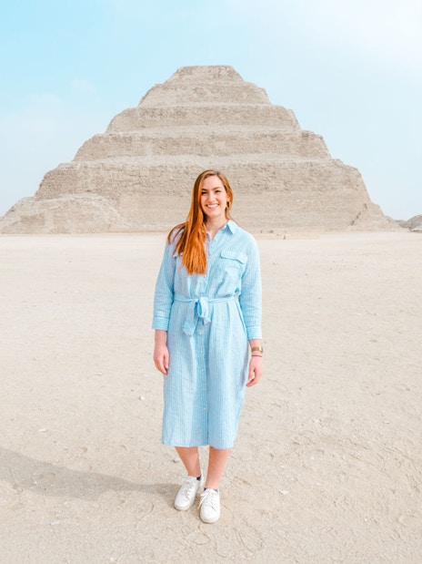 Person standing in front of the Pyramid of Djoser in Giza, Egypt.