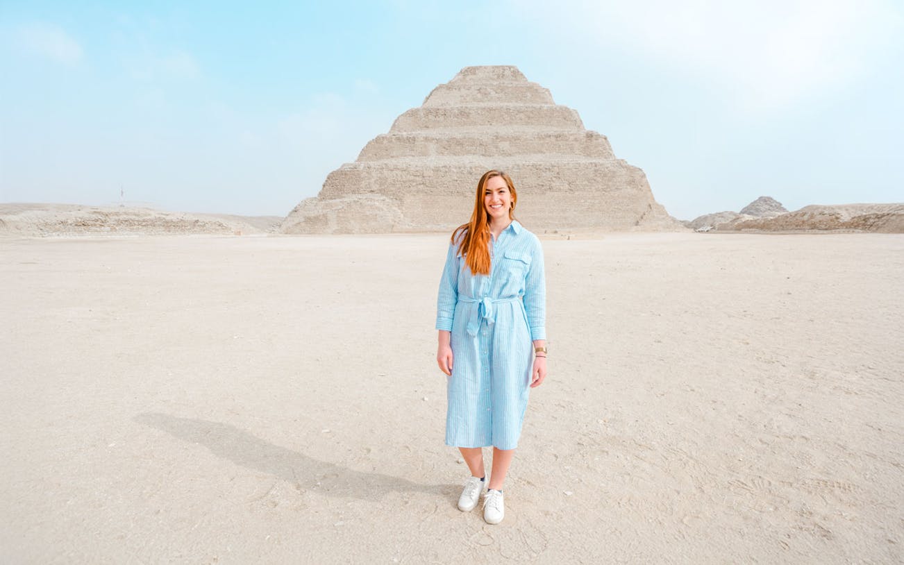 Person standing in front of the Pyramid of Djoser in Giza, Egypt.
