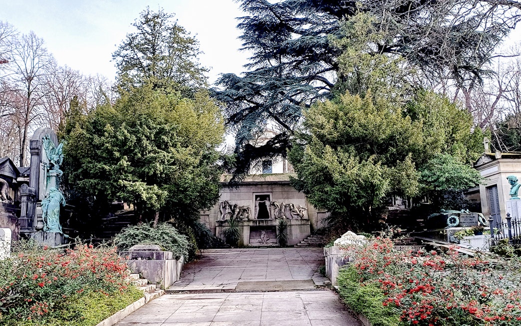 Pathway leading to ornate tombs at Père Lachaise Cemetery, Paris.