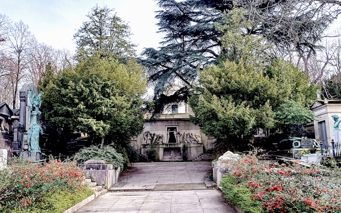 Pathway leading to ornate tombs at Père Lachaise Cemetery, Paris.
