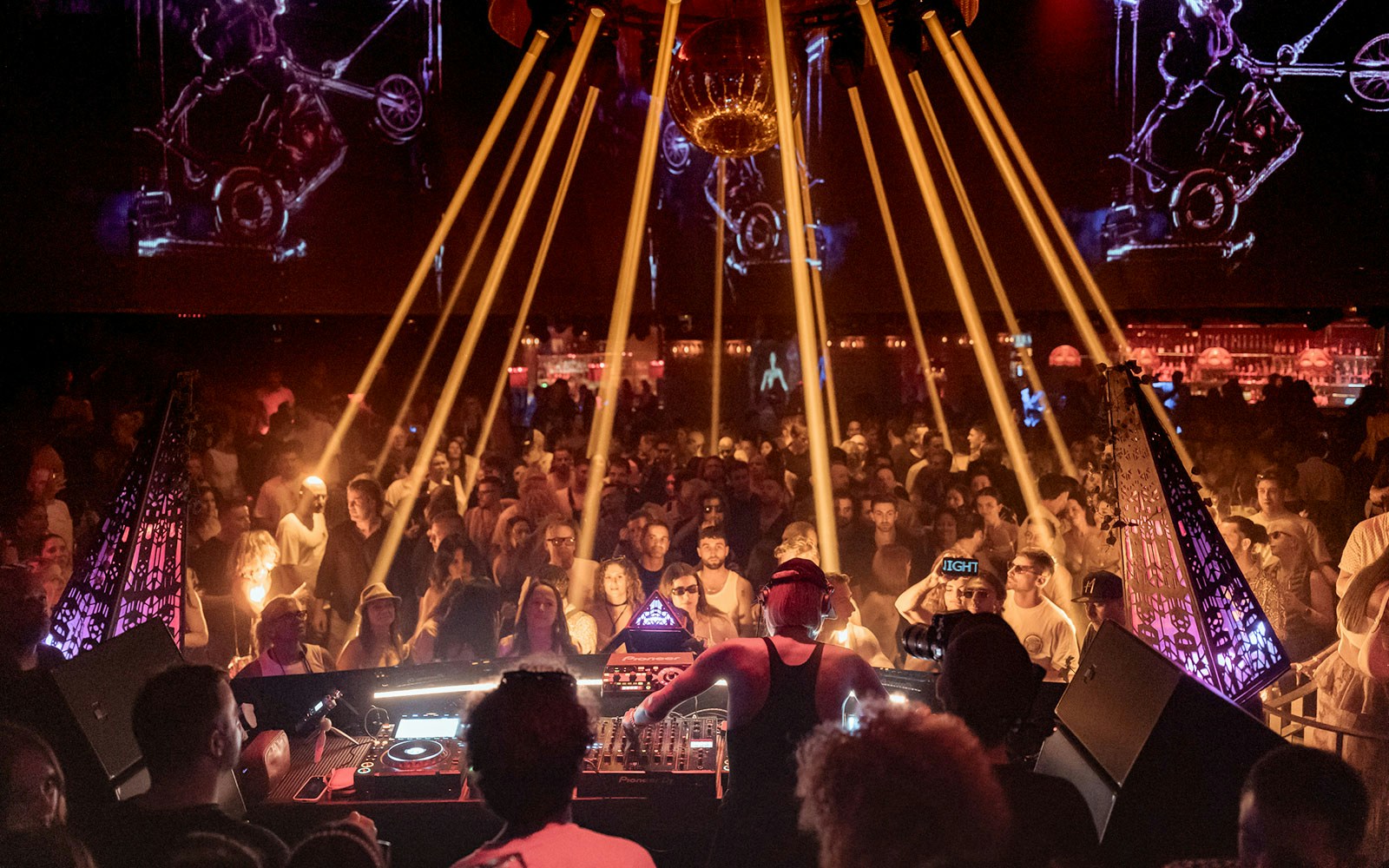 Honey Dijon DJing at Club Chinois, Ibiza with an energetic crowd enjoying the music.