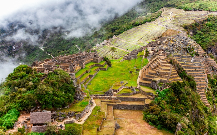 View of Machu Picchu terraces and ruins from Huchuy Picchu summit.