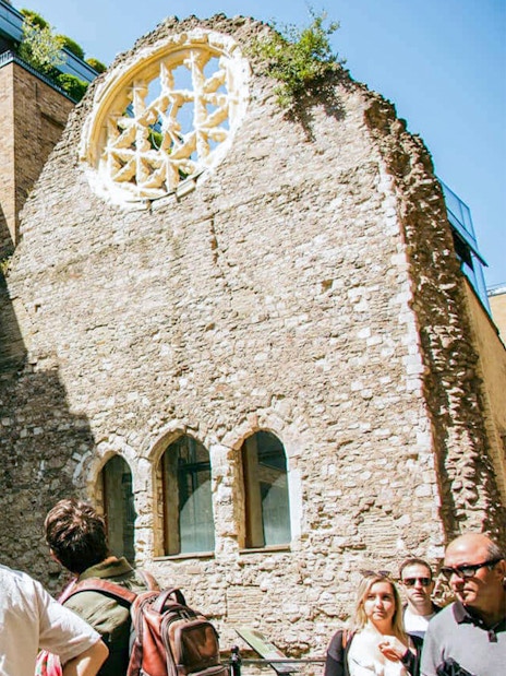 Visitors exploring historic ruins on the Eating London: Borough Market & Bankside Food Tour.