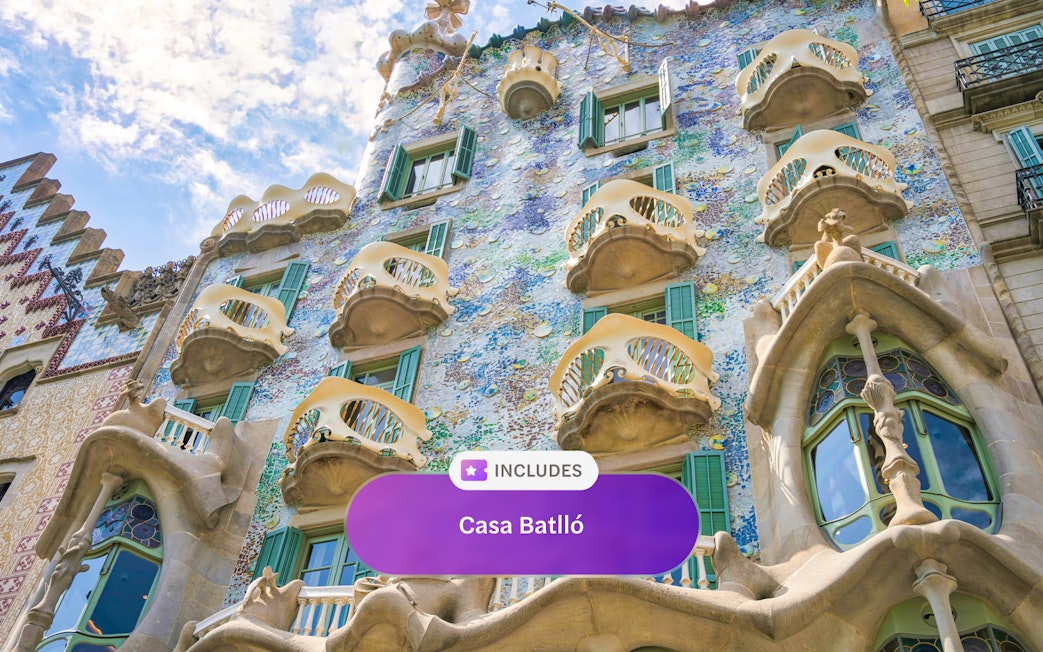 Casa Batlló facade with colorful mosaic tiles and unique balconies in Barcelona.