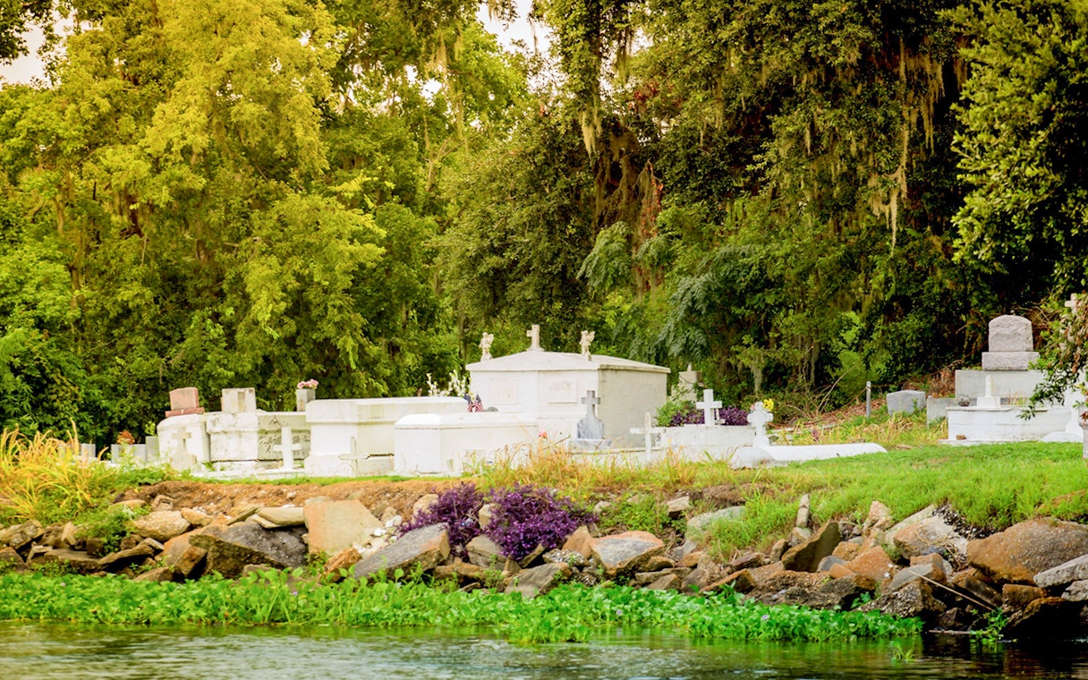 Cemetery along the water during Swamp Tour & Oak Alley Plantation Tour.