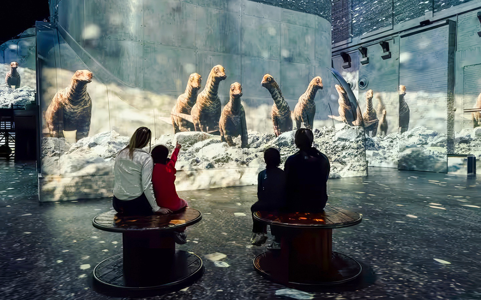 Visitors watching dinosaur projections at Prehistoric Planet: Dinosaurs – The Immersive Experience.