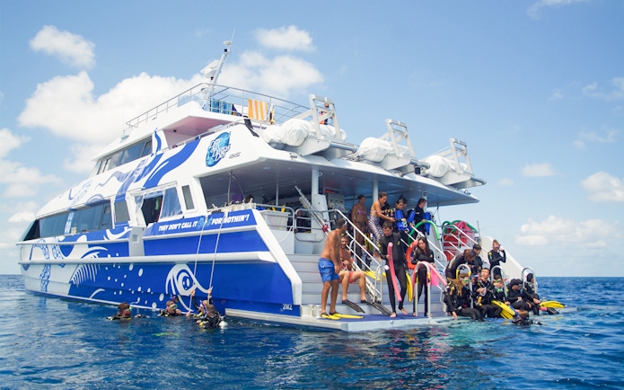 Tourists preparing to dive from a boat on the Outer Great Barrier Reef trip from Cairns.